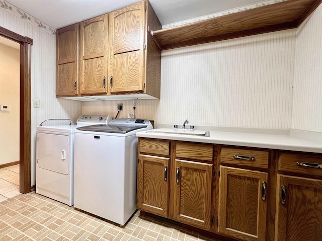 86 Ledgebrook Dr, Fond Du Lac, WI 54935 - washroom with wallpapered walls, cabinet space, washing machine and dryer, brick patterned floors, and baseboards