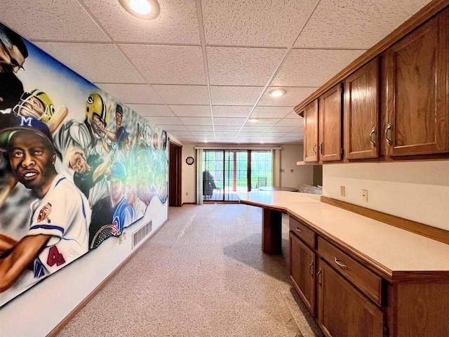 86 Ledgebrook Dr, Fond Du Lac, WI 54935 - kitchen with a drop ceiling, light carpet, brown cabinets, light countertops, and recessed lighting