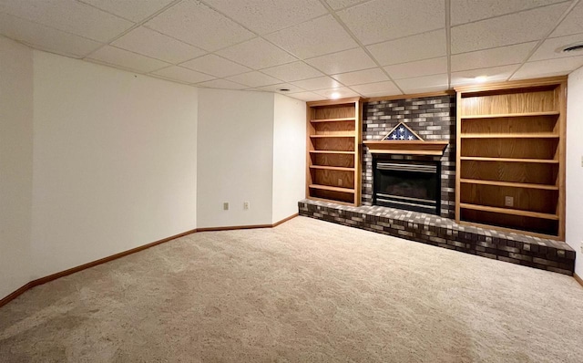 86 Ledgebrook Dr, Fond Du Lac, WI 54935 - unfurnished living room with carpet, baseboards, a brick fireplace, built in shelves, and a paneled ceiling