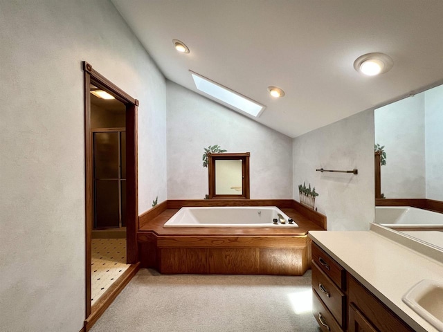 86 Ledgebrook Dr, Fond Du Lac, WI 54935 - bathroom with a skylight, vaulted ceiling, a stall shower, a bath, and vanity
