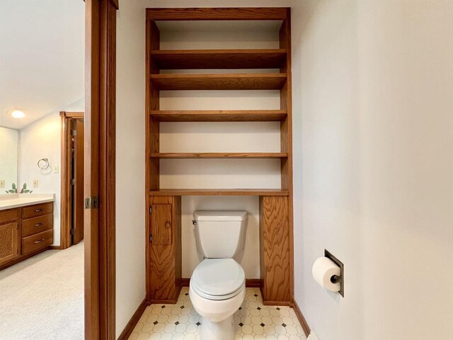 86 Ledgebrook Dr, Fond Du Lac, WI 54935 - bathroom featuring toilet, vanity, tile patterned floors, and baseboards