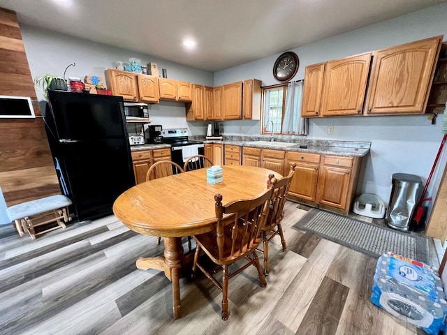 420 W Ramsdell St, Marion, WI 54950 - kitchen featuring appliances with stainless steel finishes, a sink, dark wood-type flooring, and light countertops