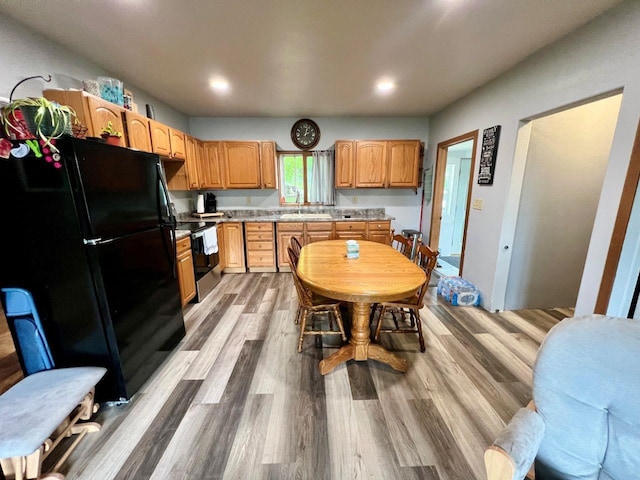 420 W Ramsdell St, Marion, WI 54950 - kitchen featuring freestanding refrigerator, stainless steel electric range, a sink, wood finished floors, and light countertops