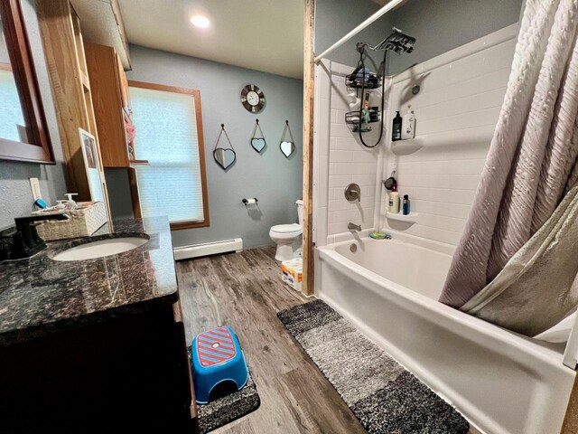 420 W Ramsdell St, Marion, WI 54950 - bathroom featuring baseboard heating, toilet, wood finished floors, shower / tub combo, and vanity