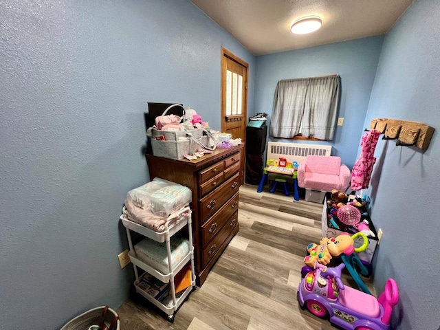 420 W Ramsdell St, Marion, WI 54950 - bedroom featuring light wood-style flooring and a textured wall