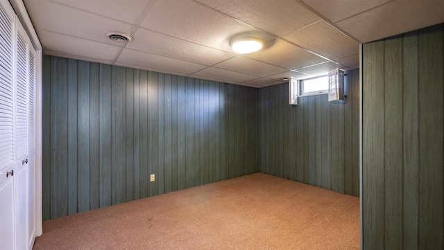 N2757 Shadow Rd, Waupaca, WI 54981 - basement featuring carpet, wooden walls, and a drop ceiling