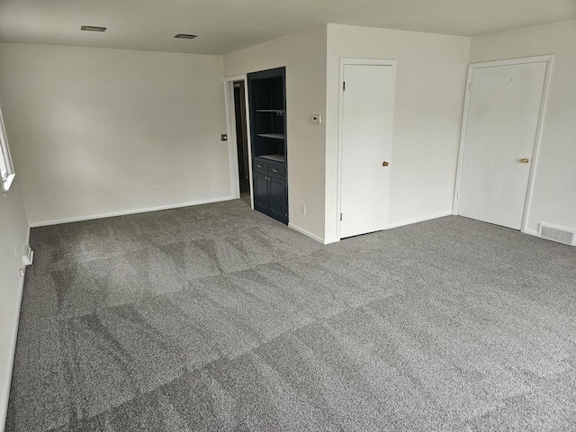 2416 N 69th St Unit 2418, Wauwatosa, WI 53213 - spare room featuring dark carpet and baseboards