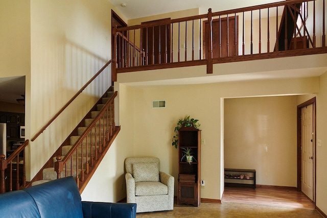 1810 W Upham Ct, Milwaukee, WI 53221 - living room with stairway, a high ceiling, baseboards, and wood finished floors