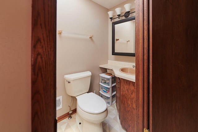 1810 W Upham Ct, Milwaukee, WI 53221 - half bath featuring toilet, vanity, and tile patterned floors