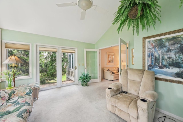 living room featuring carpet, a ceiling fan, baseboards, and high vaulted ceiling