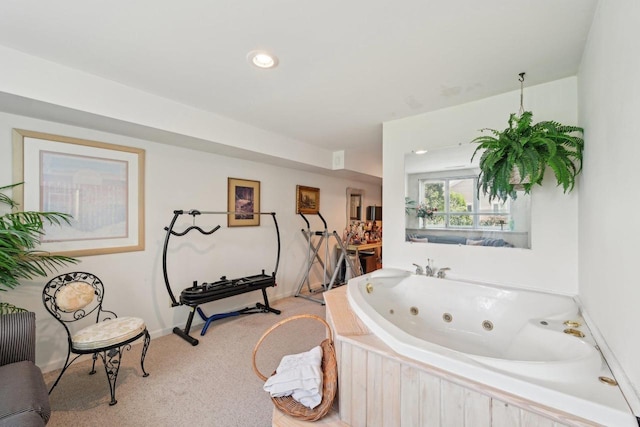 full bath with a whirlpool tub and baseboards