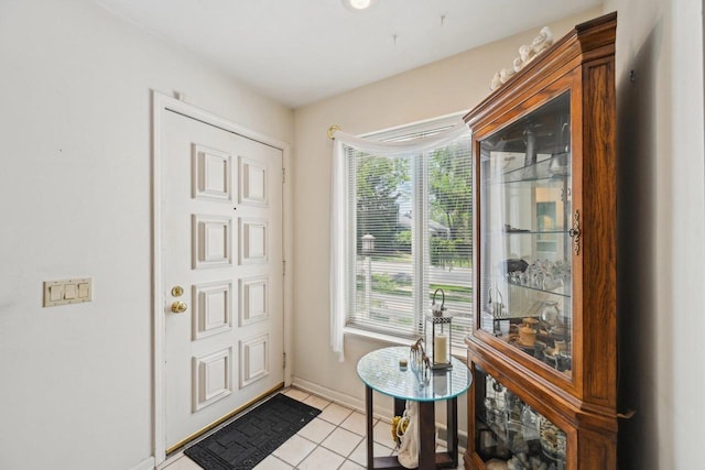 entryway featuring light tile patterned flooring and baseboards