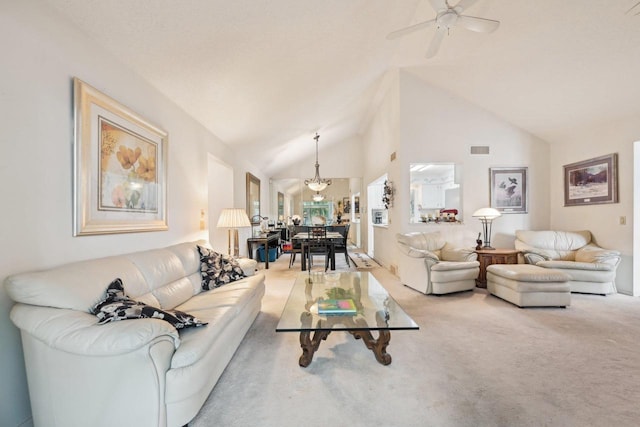 carpeted living room featuring a chandelier, a ceiling fan, and high vaulted ceiling