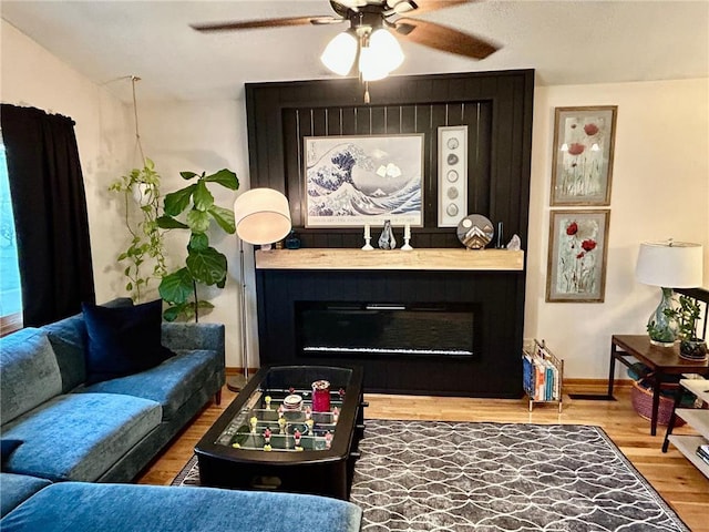6640 Falstaff Rd, Saint Paul, MN 55125 - living room with a large fireplace, wood finished floors, ceiling fan, and baseboards