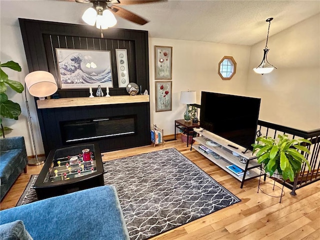6640 Falstaff Rd, Saint Paul, MN 55125 - living room featuring a fireplace, ceiling fan, wood finished floors, and baseboards