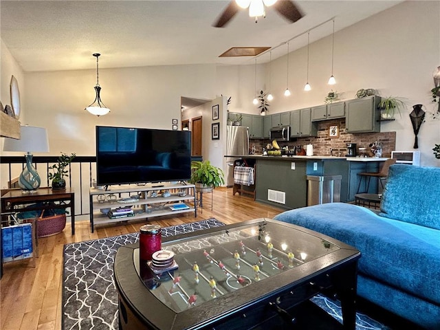 6640 Falstaff Rd, Saint Paul, MN 55125 - living area with a ceiling fan, wood finished floors, and high vaulted ceiling