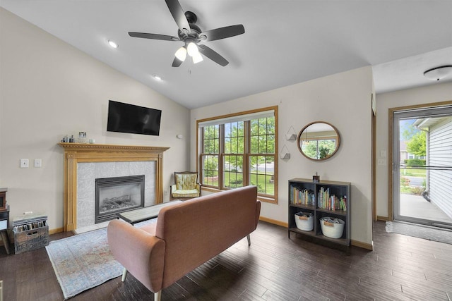 7217 Iris Bloom Dr, Madison, WI 53719 - living area featuring vaulted ceiling, wood finished floors, ceiling fan, baseboards, and a tiled fireplace