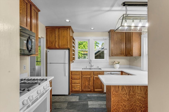 202 Lake Dr, South Milwaukee, WI 53172 - kitchen featuring white appliances, a sink, light countertops, brown cabinetry, and recessed lighting