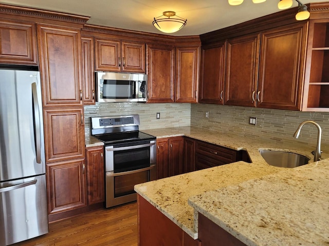 1610 N Prospect Ave Unit 506, Milwaukee, WI 53202 - kitchen with appliances with stainless steel finishes, a sink, open shelves, and light stone counters