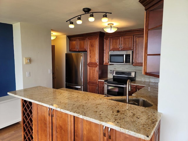 1610 N Prospect Ave Unit 506, Milwaukee, WI 53202 - kitchen featuring stainless steel appliances, a sink, decorative backsplash, and light stone counters
