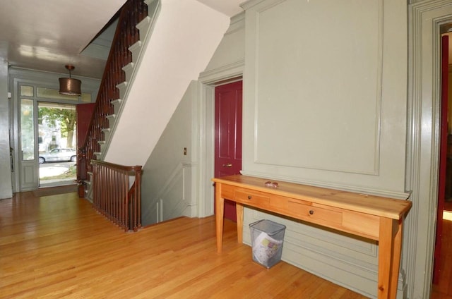 811 Jenifer St, Madison, WI 53703 - corridor featuring light wood-style flooring, a decorative wall, and stairway