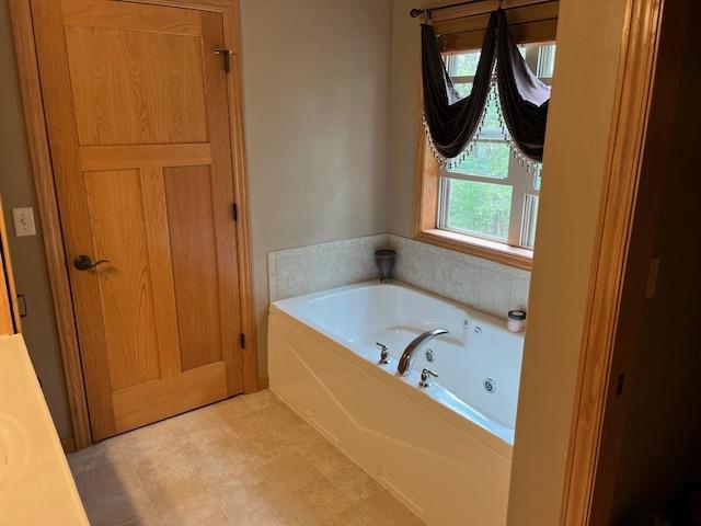 1030 Woodland Ct, Plover, WI 54467 - bathroom featuring a whirlpool tub