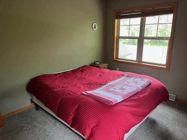 1030 Woodland Ct, Plover, WI 54467 - bedroom with carpet and baseboards