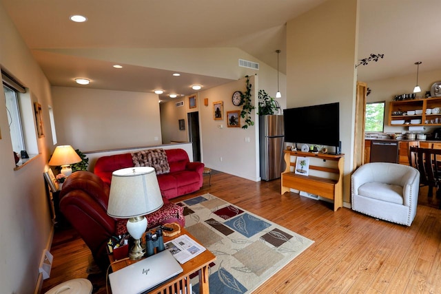 4905 Starlight Ln, Cassville, WI 53806 - living room featuring vaulted ceiling, wood finished floors, and recessed lighting