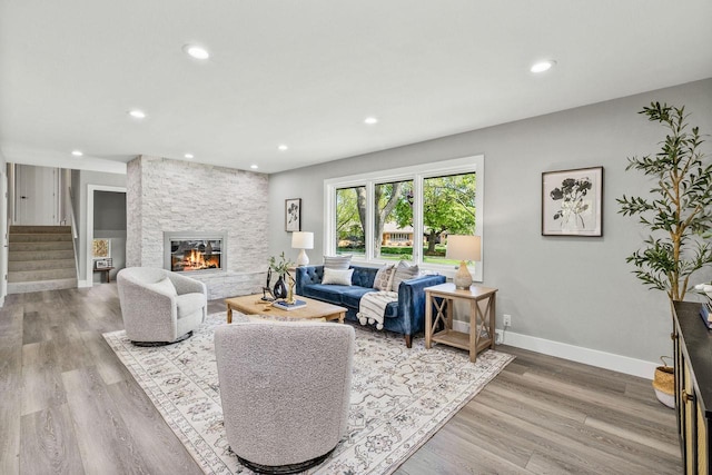250 W Suburban Ct, Fox Point, WI 53217 - living room with recessed lighting, a stone fireplace, stairway, wood finished floors, and baseboards