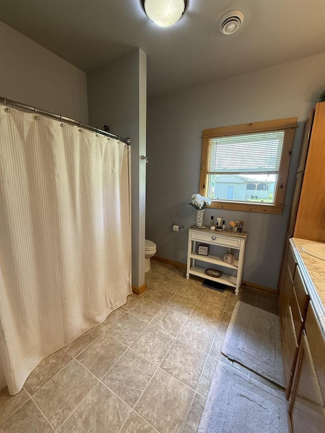 E12742 Weigands Bay N, Merrimac, WI 53561 - full bath featuring vanity, toilet, baseboards, and a shower with curtain