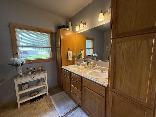 E12742 Weigands Bay N, Merrimac, WI 53561 - bathroom with double vanity, tile patterned floors, and baseboards