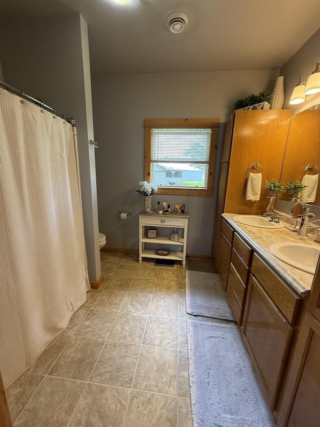 E12742 Weigands Bay N, Merrimac, WI 53561 - full bath featuring double vanity, toilet, curtained shower, and tile patterned floors