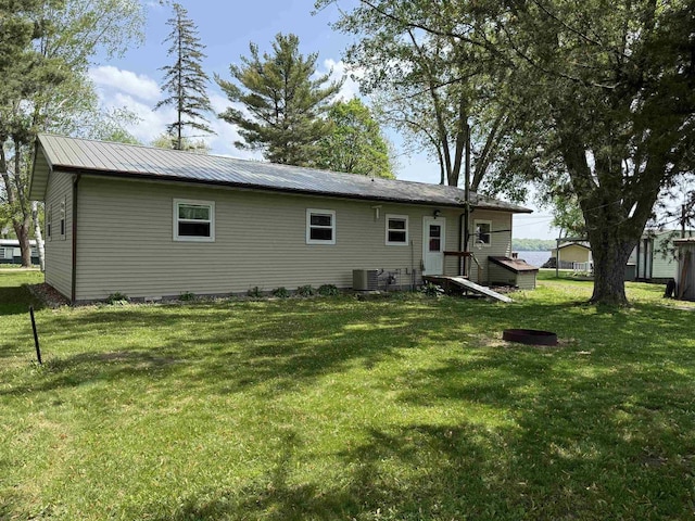 E12742 Weigands Bay N, Merrimac, WI 53561 - back of property featuring central AC unit, a yard, and metal roof