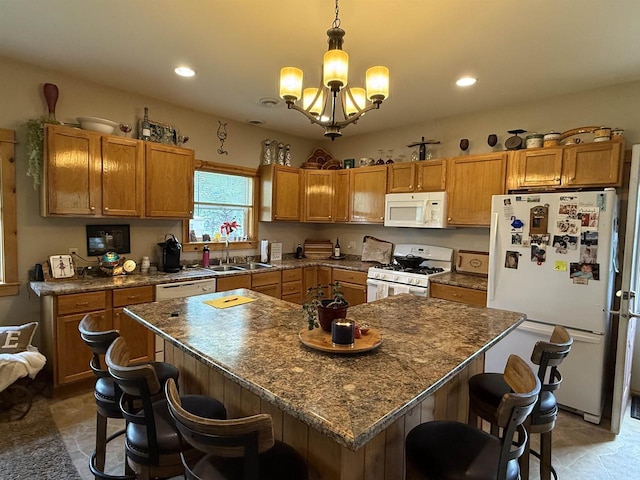 E12742 Weigands Bay N, Merrimac, WI 53561 - kitchen featuring white appliances, a sink, a chandelier, a kitchen bar, and dark countertops