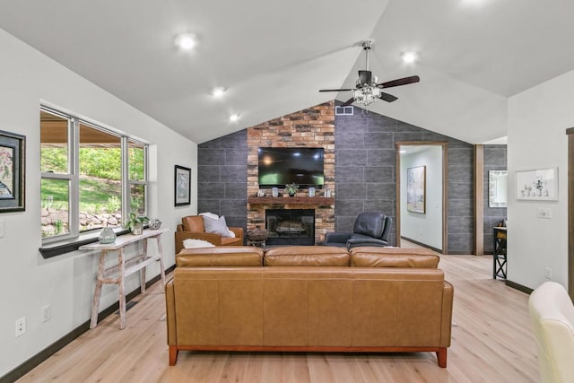 S7698 Grandview Ave, Merrimac, WI 53561 - living area featuring a large fireplace, ceiling fan, vaulted ceiling, light wood-style flooring, and baseboards