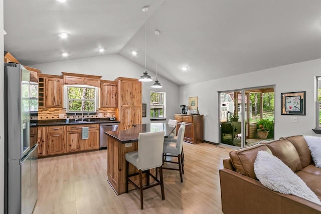 S7698 Grandview Ave, Merrimac, WI 53561 - kitchen featuring open floor plan, appliances with stainless steel finishes, a kitchen breakfast bar, light wood finished floors, and dark countertops