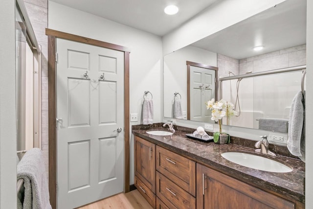 S7698 Grandview Ave, Merrimac, WI 53561 - bathroom with a shower stall, wood finished floors, and double vanity