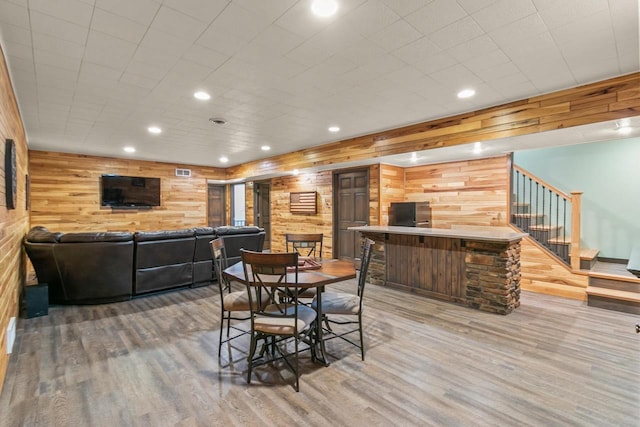 S7698 Grandview Ave, Merrimac, WI 53561 - dining room featuring wood walls, light wood-style flooring, recessed lighting, and stairs