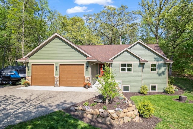S7698 Grandview Ave, Merrimac, WI 53561 - view of front facade with a garage, driveway, a front lawn, and stone siding