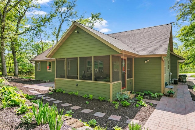 S7698 Grandview Ave, Merrimac, WI 53561 - bungalow with roof with shingles, a sunroom, and central AC