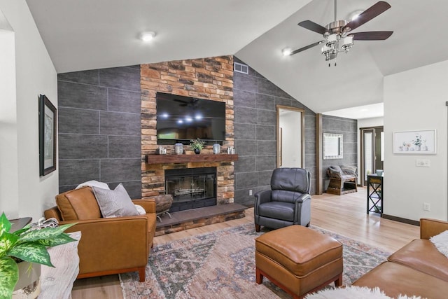 S7698 Grandview Ave, Merrimac, WI 53561 - living room with lofted ceiling, tile walls, a fireplace, wood finished floors, and a ceiling fan