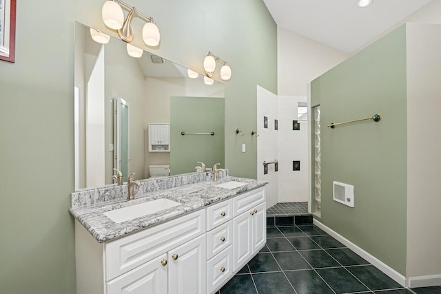 1885 Golfview Dr Unit 35-17, Lake Geneva, WI 53147 - bathroom featuring tiled shower, tile patterned flooring, toilet, baseboards, and double vanity