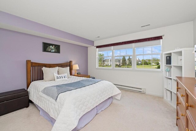 1885 Golfview Dr Unit 35-17, Lake Geneva, WI 53147 - bedroom featuring a baseboard heating unit, light carpet, and baseboards