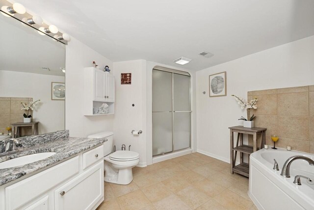 1885 Golfview Dr Unit 35-17, Lake Geneva, WI 53147 - bathroom featuring vanity, a shower stall, toilet, a garden tub, and baseboards