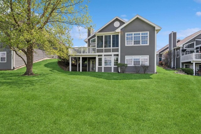 1885 Golfview Dr Unit 35-17, Lake Geneva, WI 53147 - rear view of house featuring a lawn, a chimney, and a wooden deck