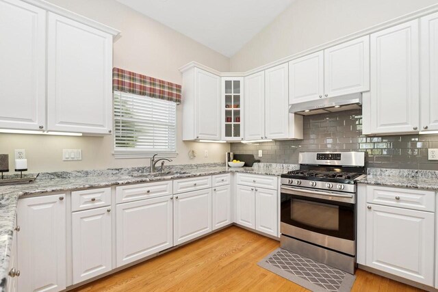 1885 Golfview Dr Unit 35-17, Lake Geneva, WI 53147 - kitchen with stainless steel gas range, under cabinet range hood, a sink, light wood-style flooring, and white cabinets