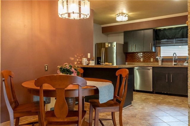 2126 Hogeboom Ave, Eau Claire, WI 54701 - kitchen featuring appliances with stainless steel finishes, decorative backsplash, a sink, a chandelier, and crown molding