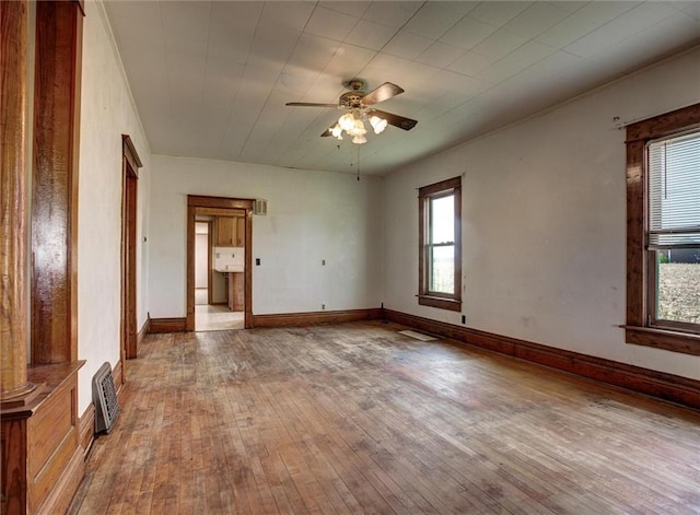 4190 County Road P, Spring Valley, WI 54767 - spare room with plenty of natural light, wood-type flooring, ceiling fan, ornamental molding, and baseboards