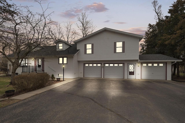 115 Glenwood Dr, Williams Bay, WI 53191 - view of front of home featuring driveway, a garage, and roof with shingles