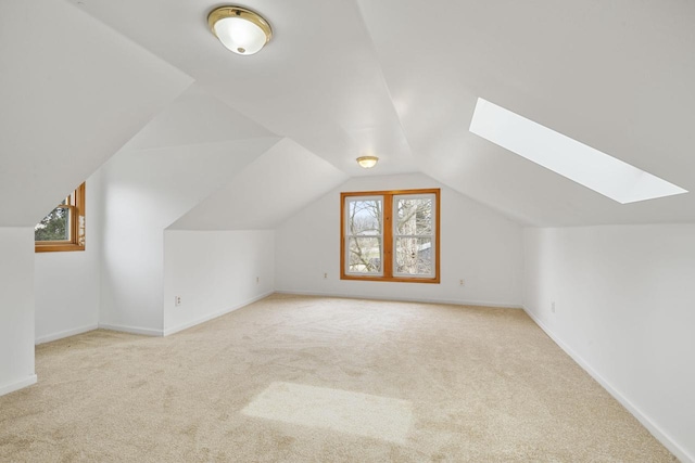 115 Glenwood Dr, Williams Bay, WI 53191 - additional living space featuring a skylight, carpet flooring, vaulted ceiling, and baseboards
